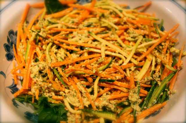 Raw pasta with pesto close up