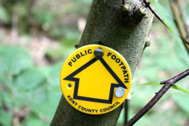public footpath sign in woods
