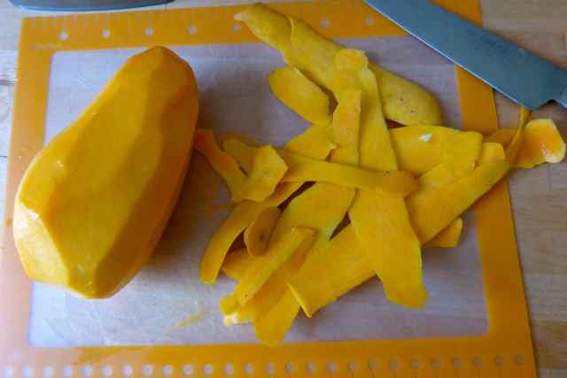peeling a honey mango